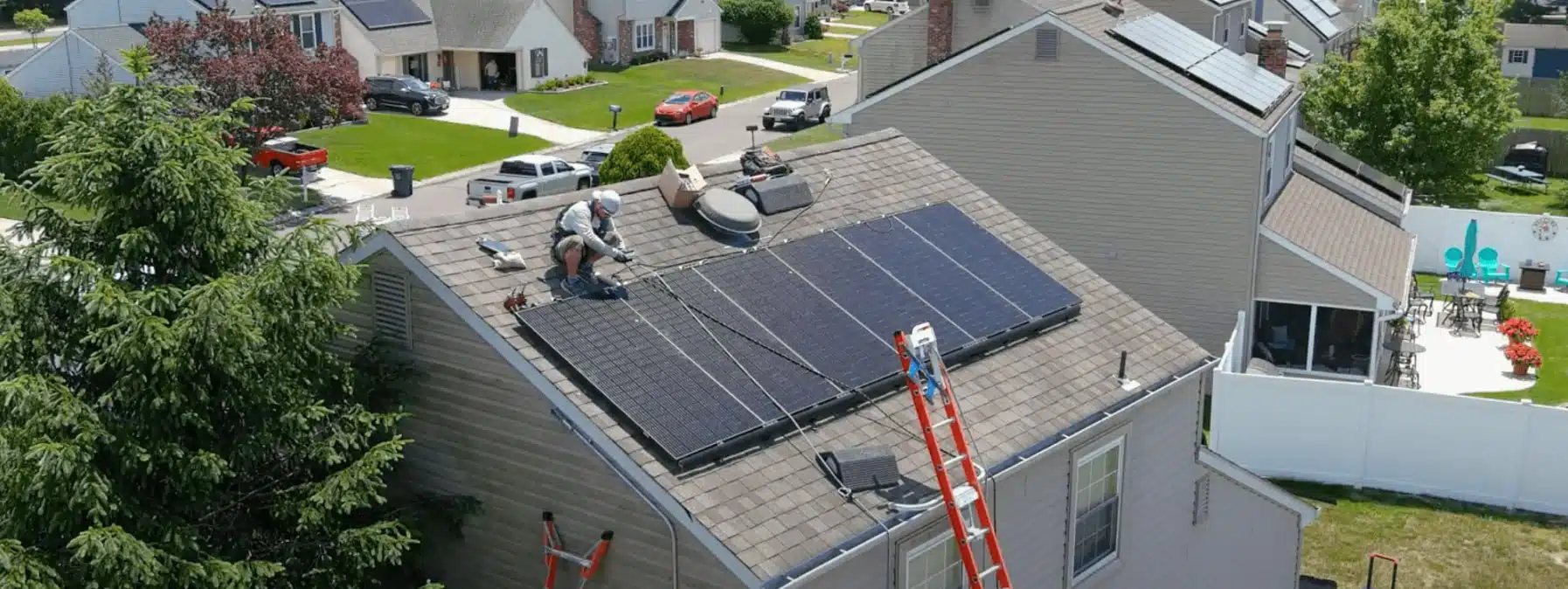 sunnymac employee installing solar panels on a roof