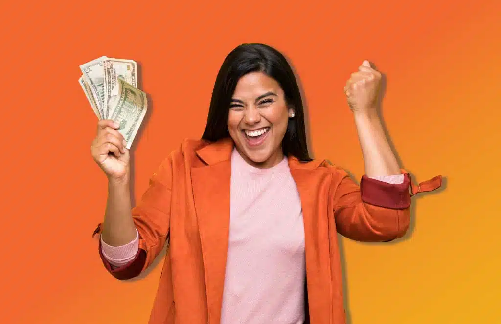 woman smiling and holding money