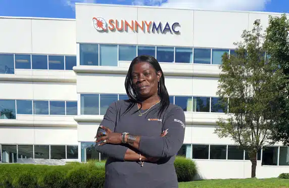 minnie standing in front of sunnymac headquarters