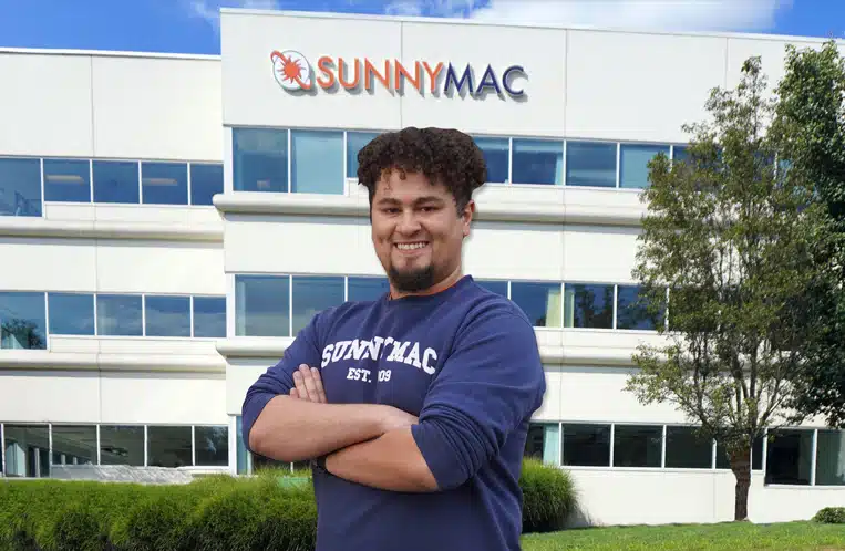 cam miller smiling in front of sunnymac building